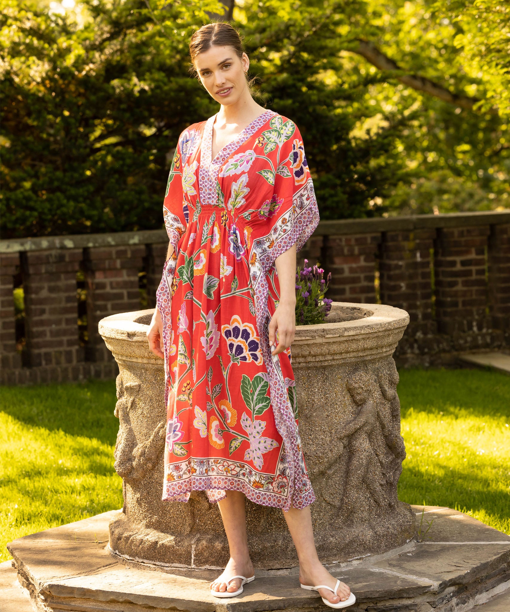 Wanderlust Maxi Caftan in color Hibiscus on a model