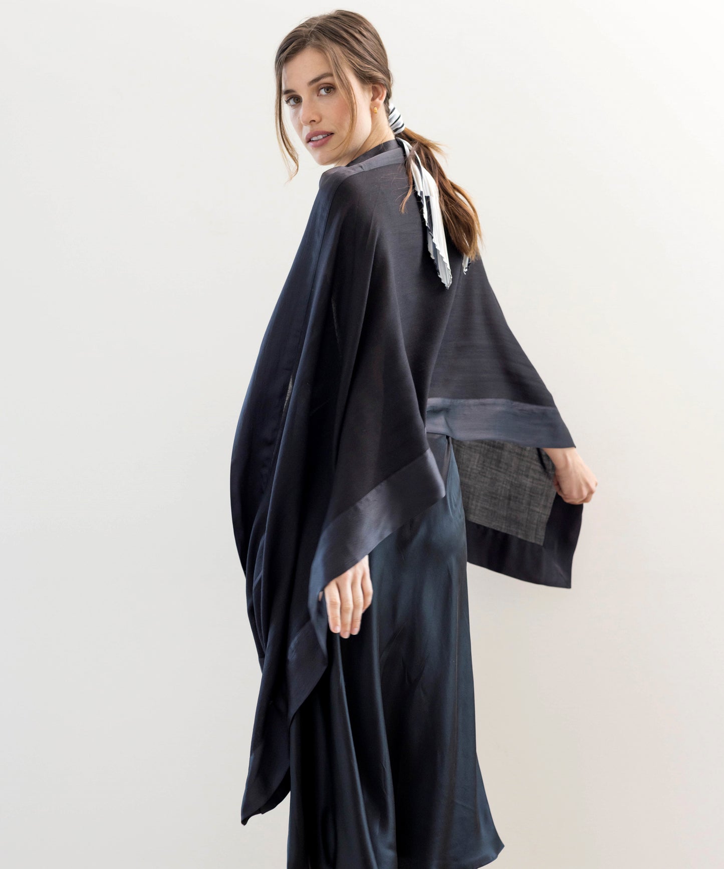 Soiree Wrap in color Black on a model