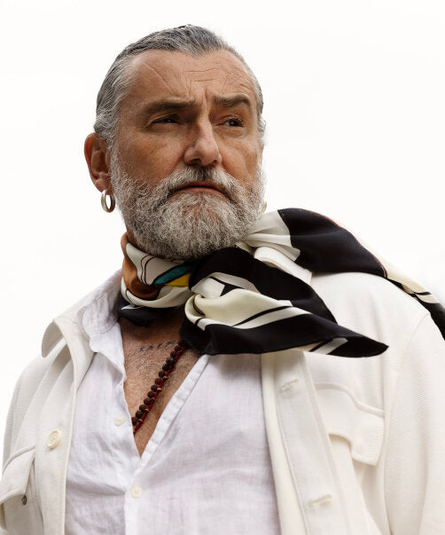 A portrait of Roberto Bonanomi wearing his Echo 100 scarf.